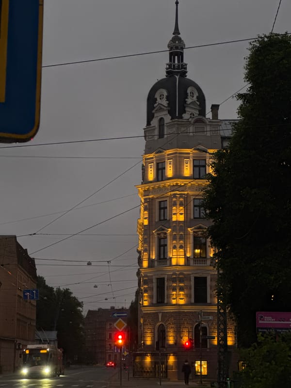 Riga street corner at dusk, Ģertrūdes church tower in view