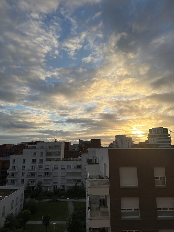 Dramatic sunset illuminates clouds over Toulouse cityscape