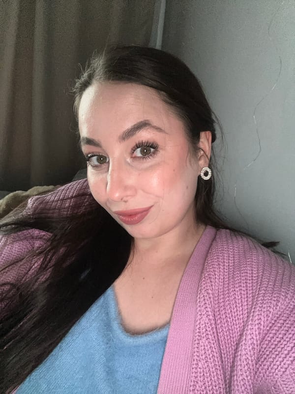 Couple shares drinks from pink mugs in Liepaja