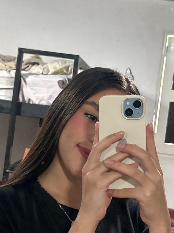 Mirror selfie in a Juan Griego bedroom, July 2026