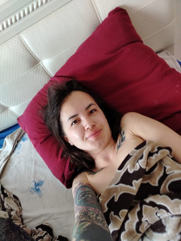 Woman rests in bed during early morning hours in Noviy