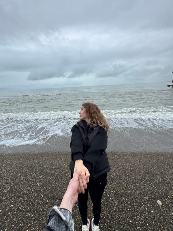 Woman spends quiet moment on Abkhazian beach during overcast day
