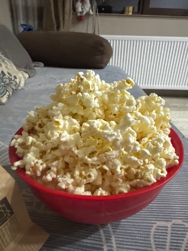 Overflowing popcorn bowl captured on couch in Lehchevo, Bulgaria