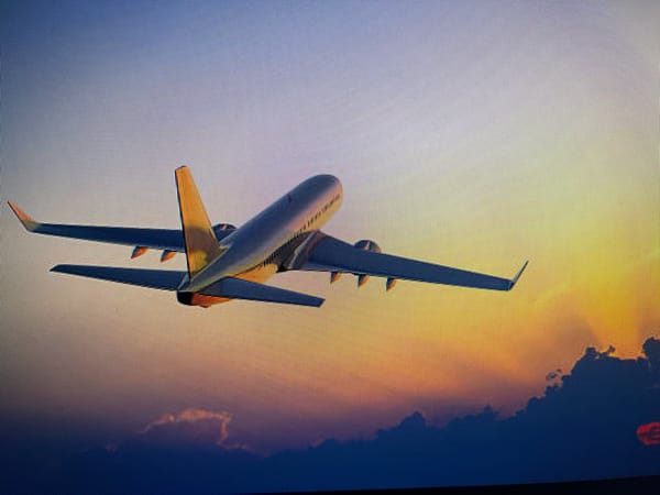 Commercial aircraft spotted over clouds at sunrise near Varna