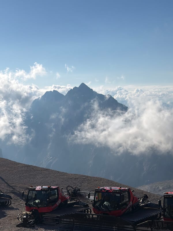 Red snow groomers parked on a Garmisch-Partenkirchen mountain slope