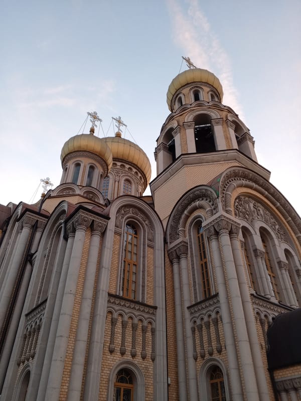 Dusk walk through a Baltic city: churches, streets, and construction