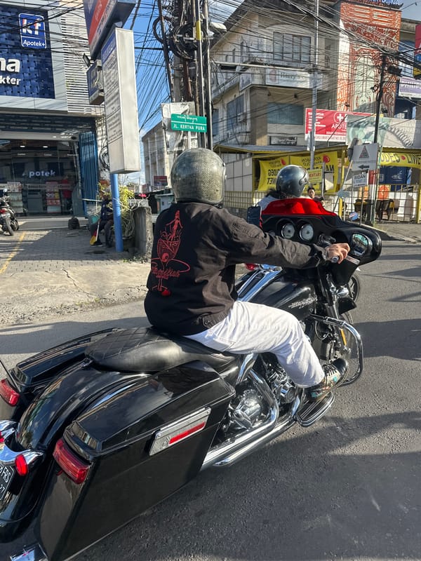 Morning motorcycle traffic on a busy Denpasar street