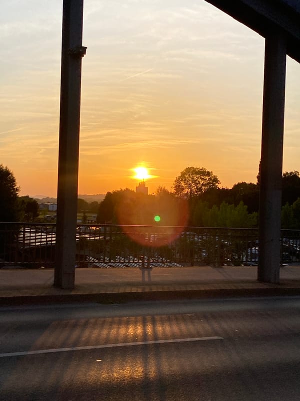 Sunset from a Rinteln bridge, coffee cup on the railing
