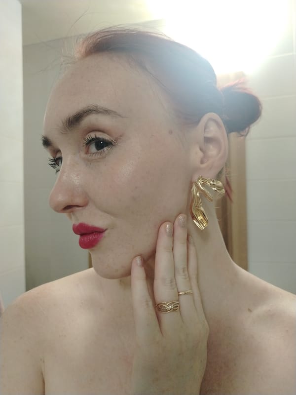 Woman photographed in winter gear, apartment building captured in Izhevsk