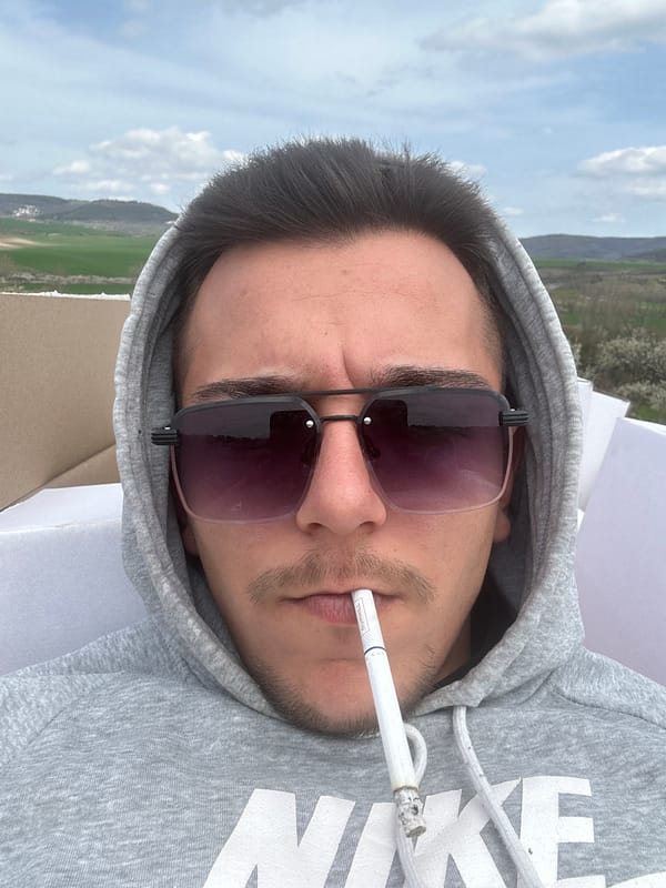 Man smoking cigarette observed in rural Novosel, Bulgaria