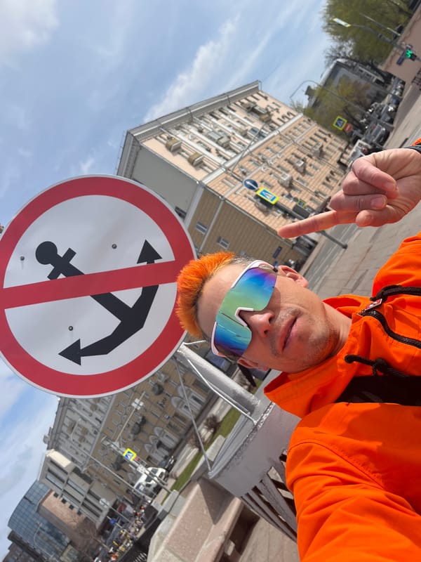 Orange-clad tourist poses by Moscow River no-anchoring sign