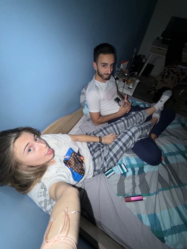 Two people relax on bed with phone in Plovdiv