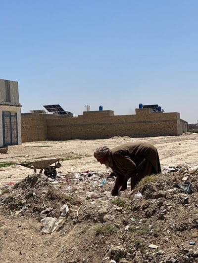 Daily life documented in Kandahar streets, children carrying water
