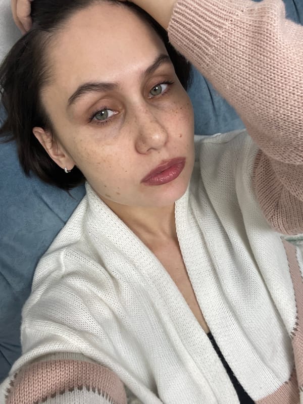 Woman photographed indoors, light snow falls outside in Izhevsk