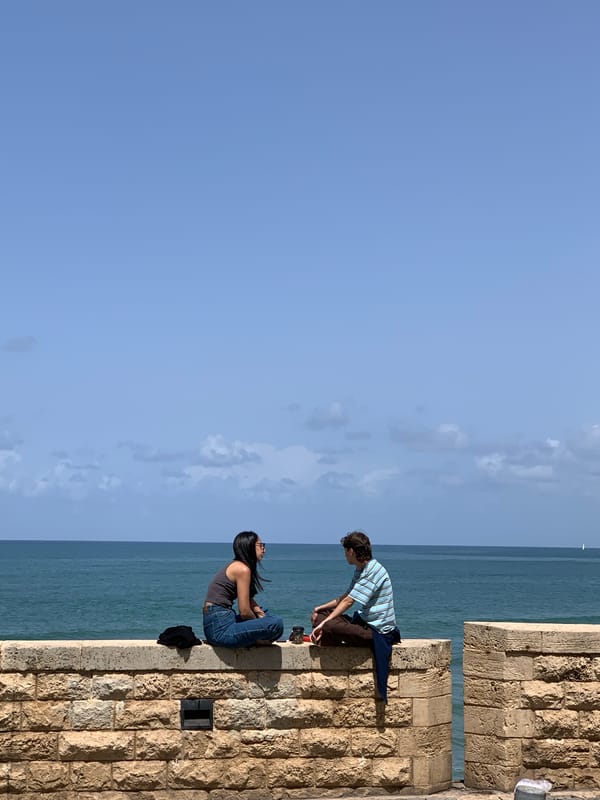 Casual Tel-Aviv moments: oceanside socializing, architecture, broken statue