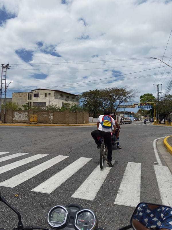 Cyclist crosses street at Juan Griego intersection