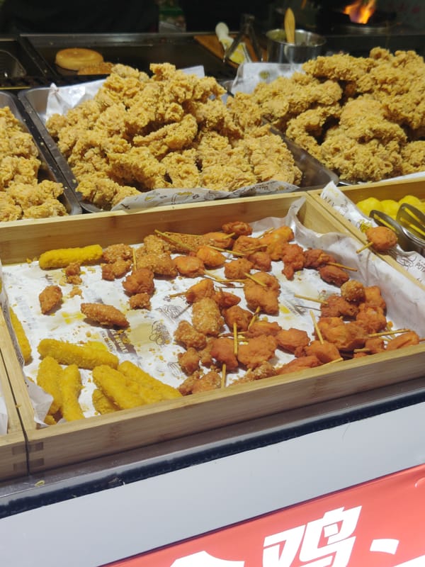 Street food vendor serves fried chicken in Shapingba District