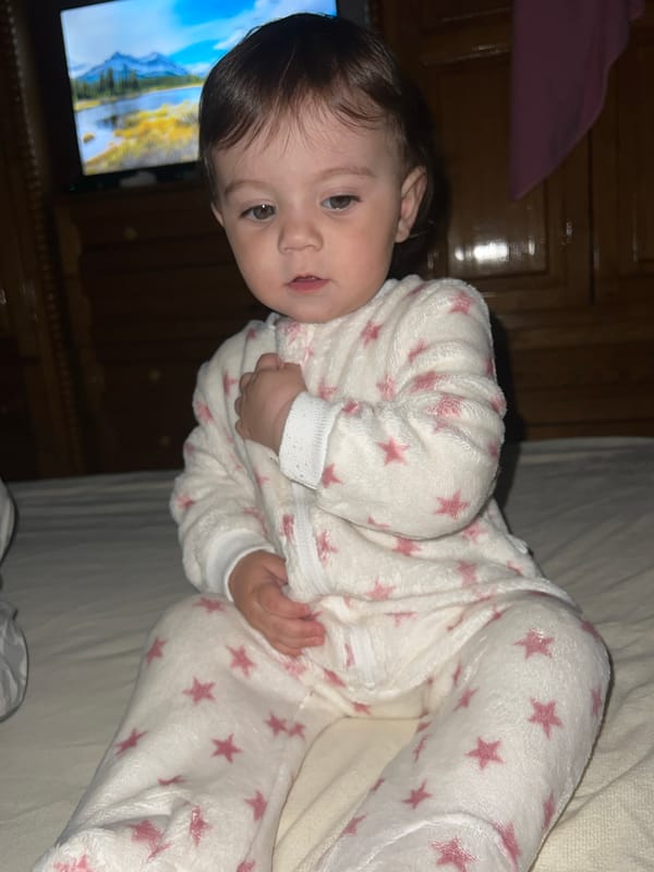 Child in star pajamas photographed at bedtime in Elena