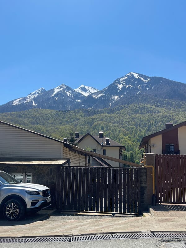 Morning street scene captured in mountain-backdrop city neighborhood