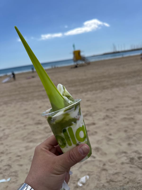 Beachgoer enjoys green smoothie drink in Palma de Mallorca