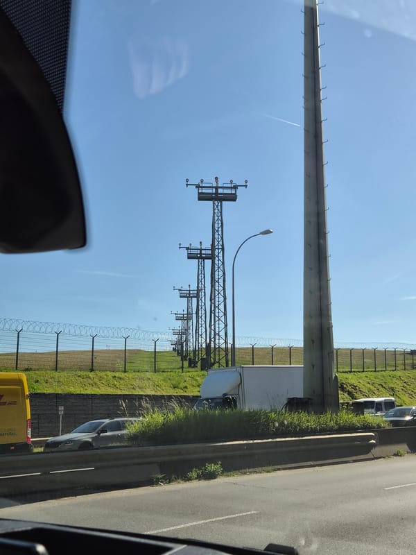 Vehicle travels road alongside Luxembourg Airport perimeter Friday morning