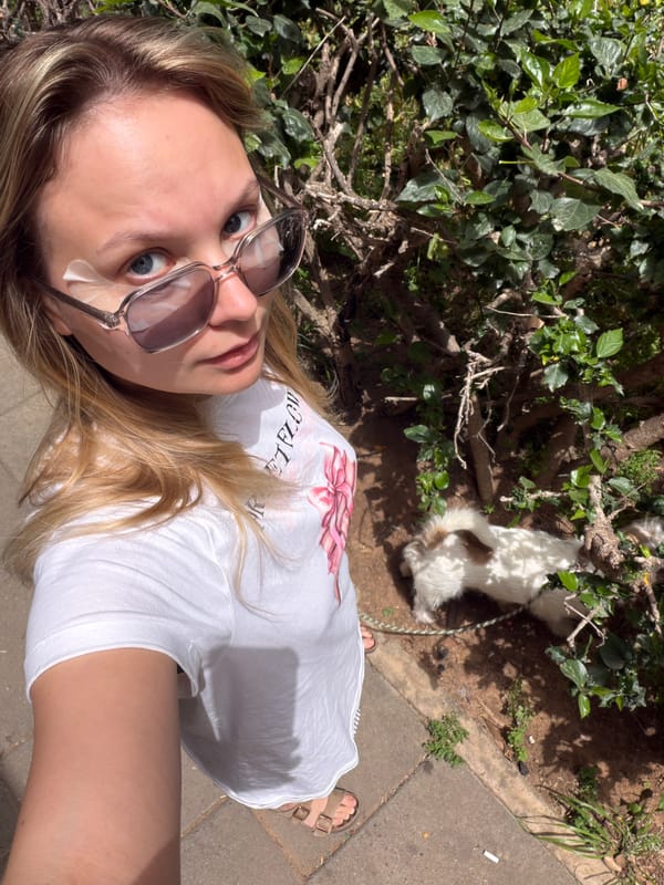 Woman takes selfie with white dog in Bat Yam