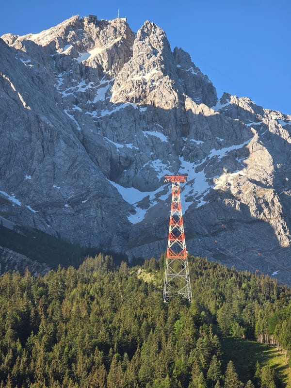 Tourist documents Zugspitze cable car system on clear morning