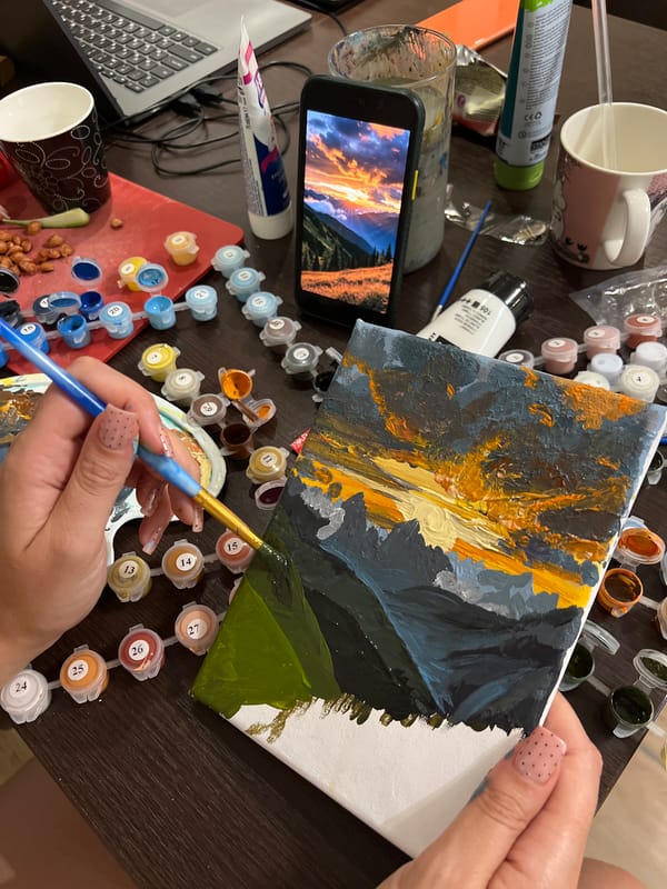 Woman paints mountain sunset landscape in Podgorica