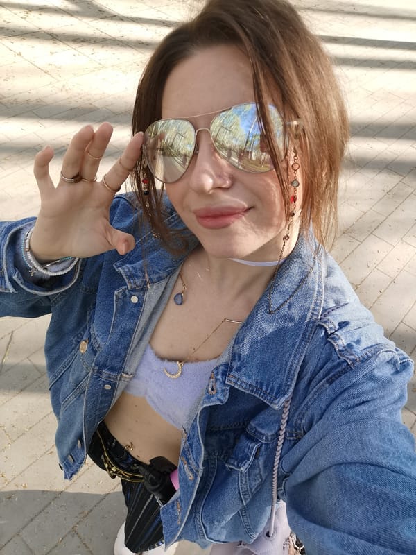 Woman takes selfies in birch forest park