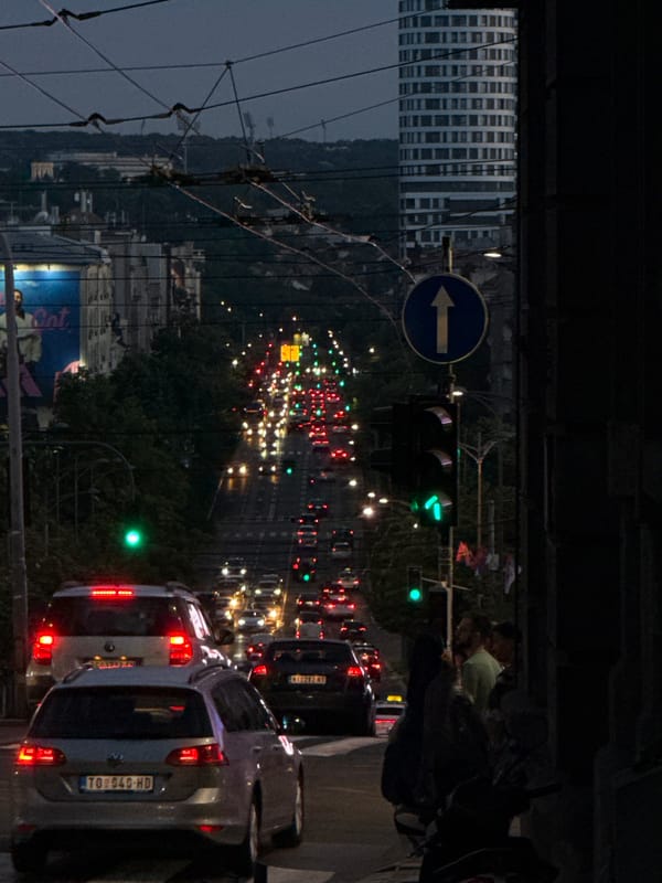 Evening traffic scenes documented across Belgrade intersections and avenues