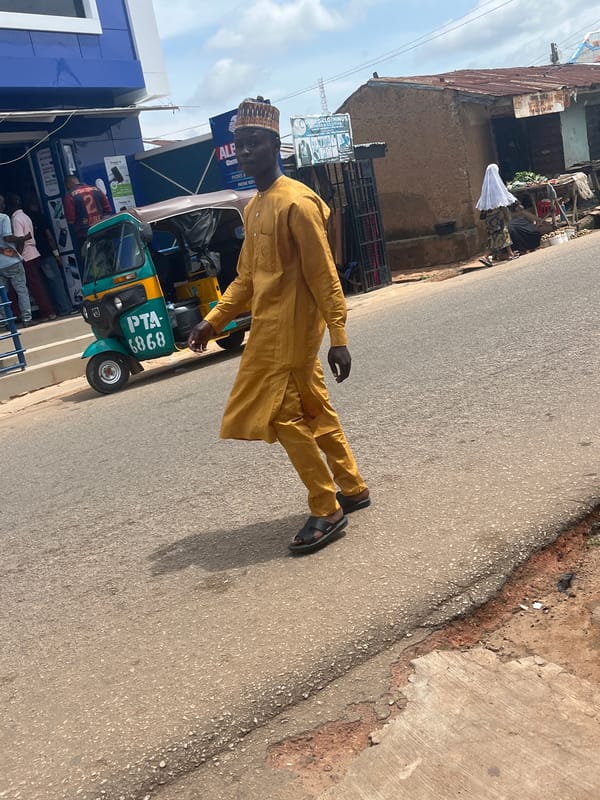 Street life around a Jos commercial block, keke and all