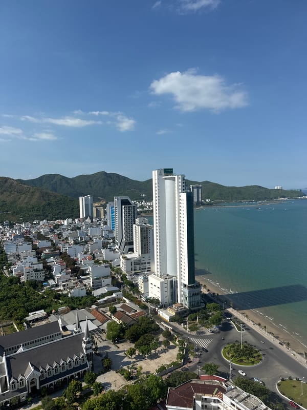 Aerial views of a mountain-backed coastal city, plus one odd clip out