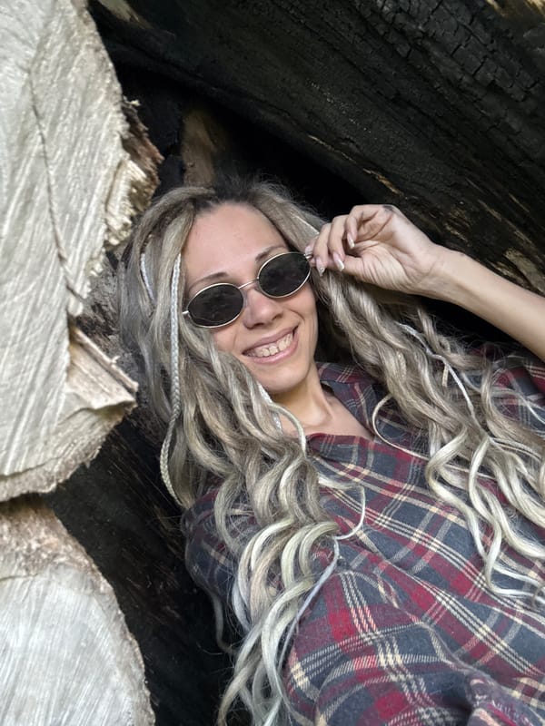 Woman poses among fallen trees in Russian woodland