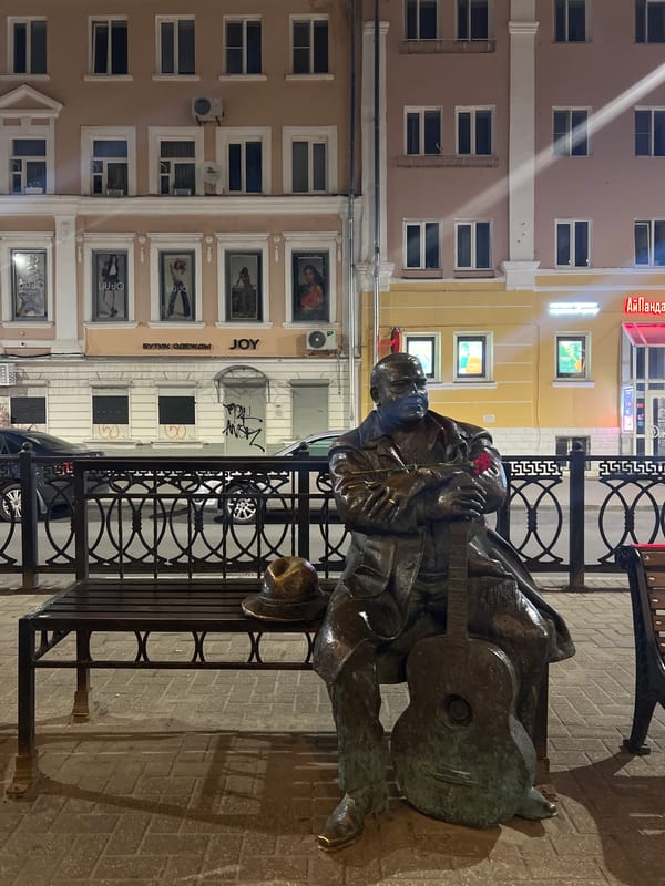 Masked musician statue with guitar and rose, Tver