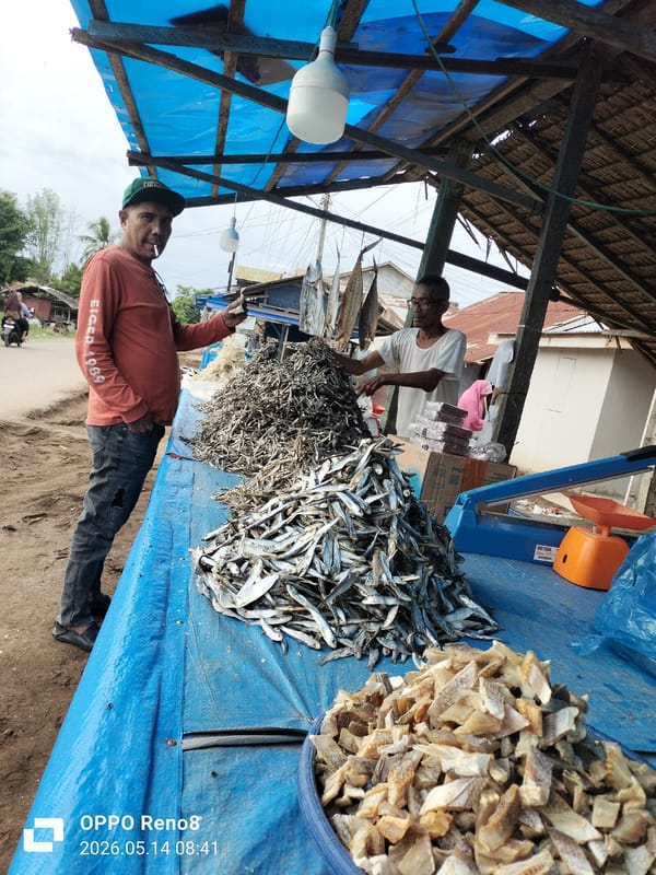Two men at covered market stall in Lhokseumawe