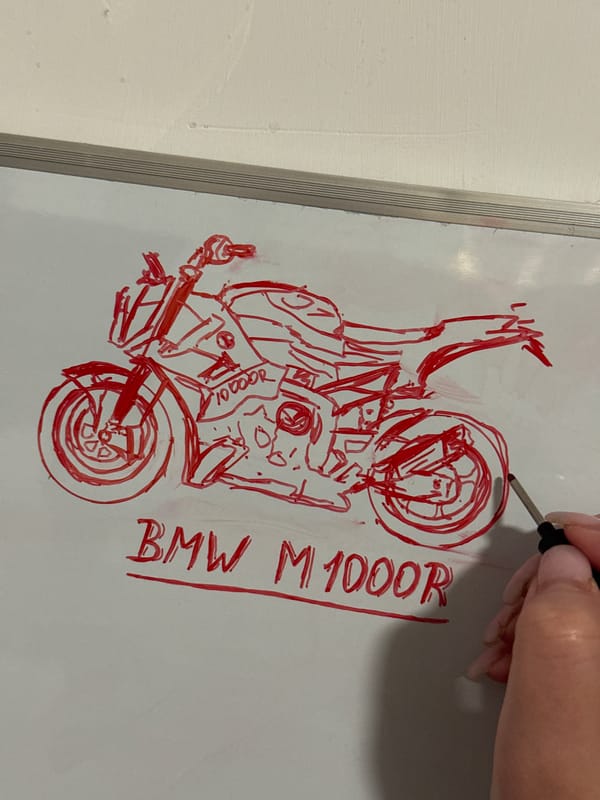 Red marker sketch of a BMW M 1000 R on a whiteboard