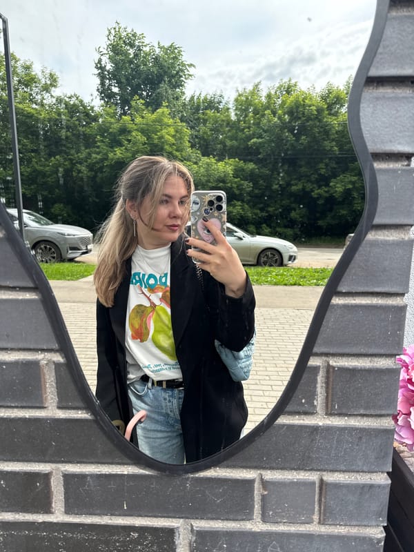 Woman takes mirror selfie with eye-patterned phone case