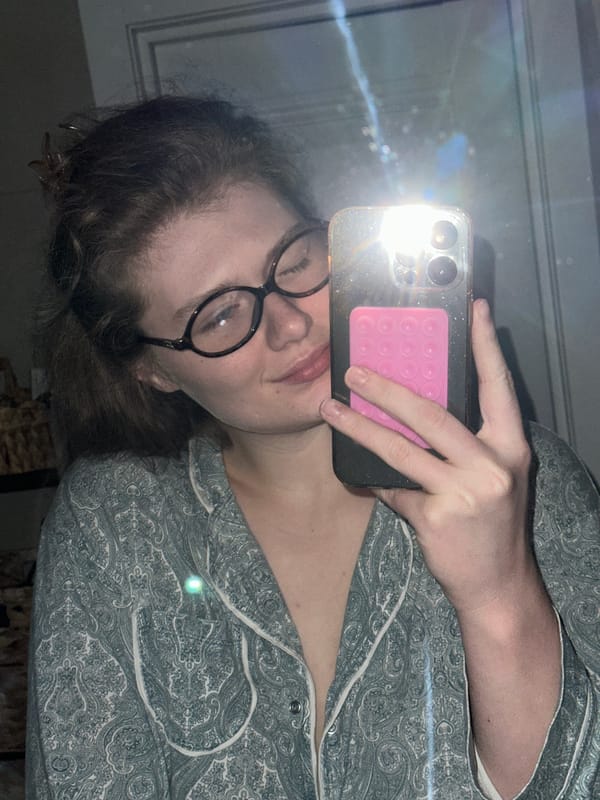 Woman takes mirror selfie in pajamas in Kazan