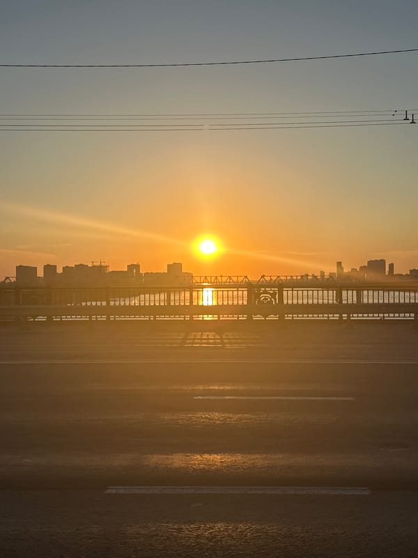 Novosibirsk bridge at golden hour, city skyline glowing