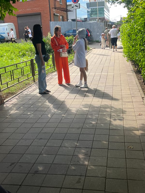 Midday street scene near Krasnodar residential blocks, June 2026