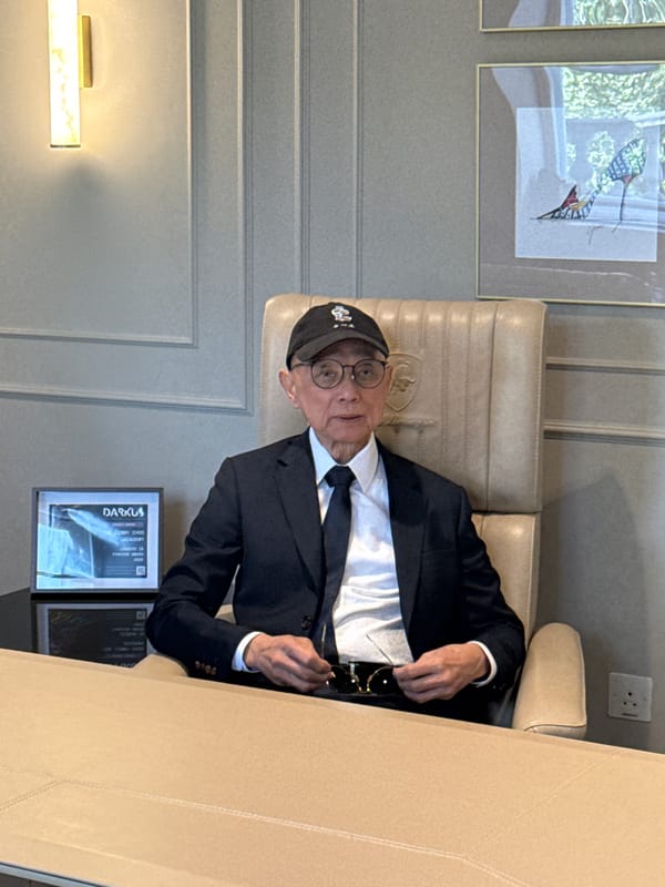 Older man in formal attire observed indoors