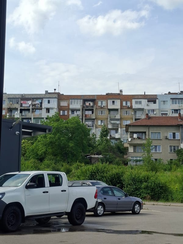 Urban scenes documented: residential building, Bulgarian-plated Toyota in garage