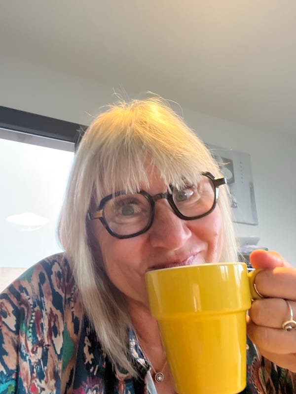 Woman drinks from yellow mug in early morning Chambœuf
