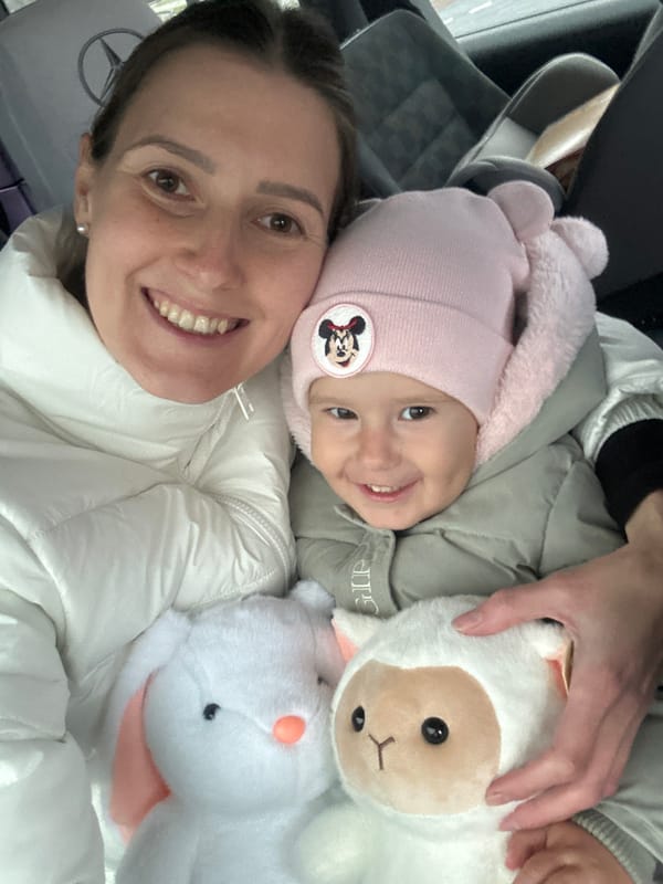 Woman and child share indoor selfie moment in Wisła