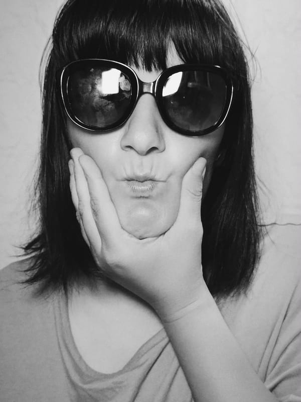 Monochrome portrait captures person in dark sunglasses