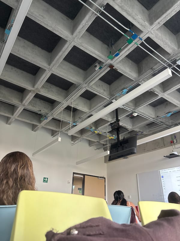 Students gather in modern industrial-style classroom with concrete ceilings