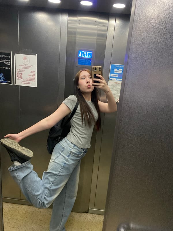 Woman takes selfies, black cat spotted in building area