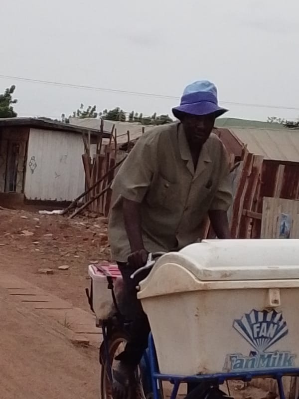 Fan Milk delivery cyclist spotted on Tamale dirt road
