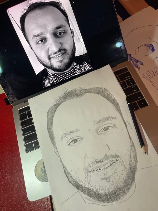 Artist sketches portrait from laptop reference in Jos