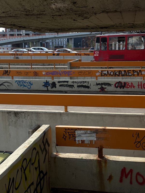 Woman photographs Belgrade's concrete overpasses during spring afternoon walk